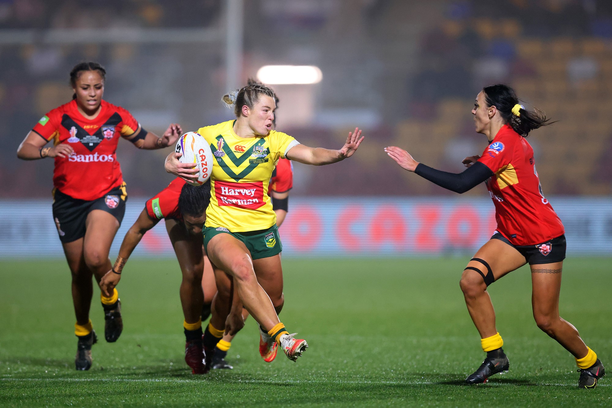 Emma Tonegato fends off Papua New Guinea's defence at the Rugby League World Cup