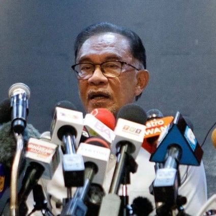 Anwar Ibrahim, Malaysia’s opposition leader (centre) speaks during a news conference on November 21. Anwar, who has come tantalisingly close to leading Malaysia during his tumultuous political career, is suddenly on the cusp of clinching the top job but a final hurdle stands in his way. Photo: Bloomberg
