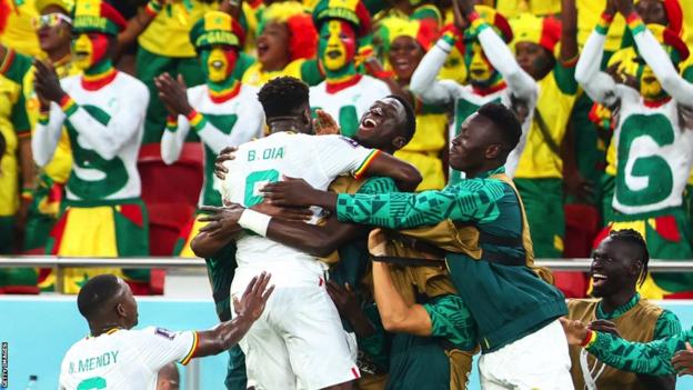 Senegal players celebrate a goal against Qatar