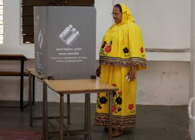 A woman waits after casting her vote at a polling booth during Gujarat state assembly election, Limbdi town of Surendranagar district, Gujarat, India, 1 December 2022 (PHOTO: Amit Dave via Reuters)