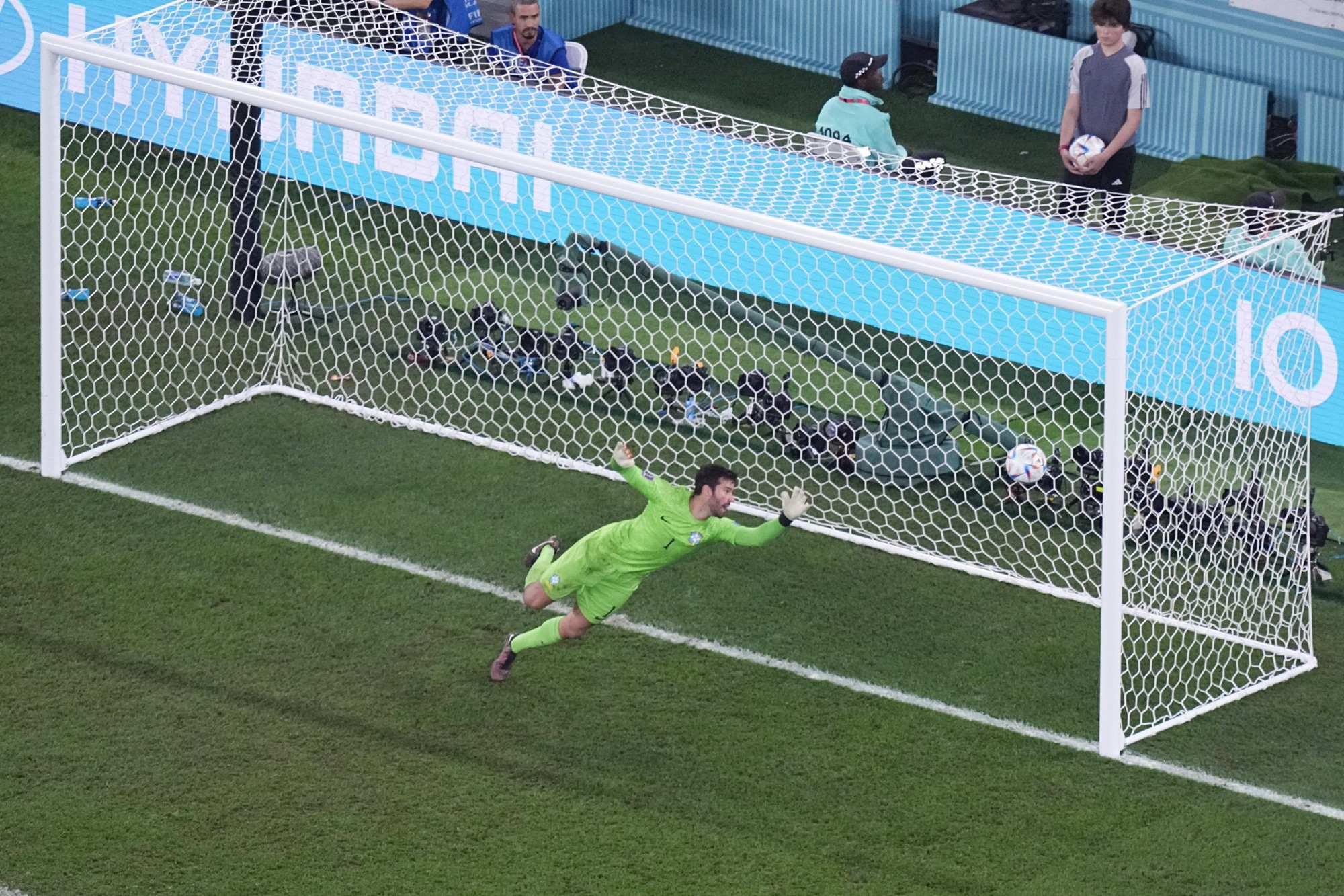 A ball goes past diving Brazilian goalkeeper Alisson during the Qatar World Cup match against South Korea.