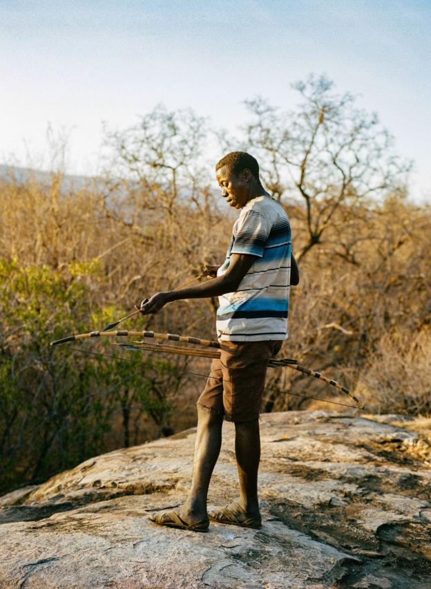 A Hadza man arms his hunting bow