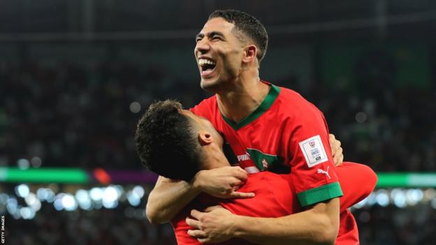 Achraf Hakimi of Morocco (right) celebrates after scoring the winning penalty against Spain
