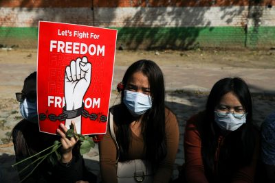 Myanmar citizens living in India hold a placard as they attend a protest, organised by pro-democracy supporters, against the military coup in Myanmar and demanding recognition of the National Unity Government of Myanmar, in New Delhi, India, 22 February 2022 (Source: Reuters/Anushree Fadnavis).