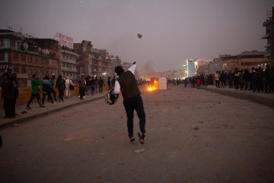 Transport workers pelting stones at police during a protest against the stringent rules of the traffic police, Balaju, Nepal, 13 February 2023 (Photo: Reuters/Rojan Shrestha).