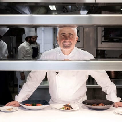 French chef Guy Savoy in the kitchen of his eponymous restaurant in the Monnaie de Paris in the French capital, which has held three Michelin stars since 2002 but has been stripped of one in the new edition of the Michelin Guide. Another three-Michelin-star French restaurant, and 20 two-star restaurants, have also lost a star. Photo: AFP