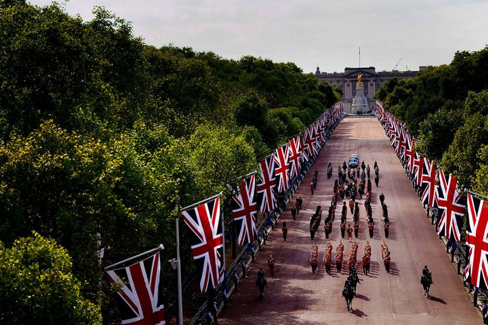 The coffin of Queen Elizabeth II, draped in the Royal Standard with the Imperial State Crown placed on top, is carried on a horse-drawn gun carriage of the King's Troop Royal Horse Artillery, during the ceremonial procession from Buckingham Palace to Westminster Hall