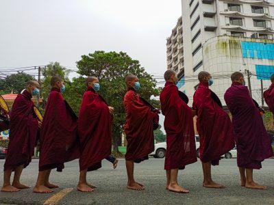 Myanmar Buddhist monks line up to collect morning alms from devotees in Yangon, Myanmar, 27 October 2022 (Photo: Reuters/NurPhoto)