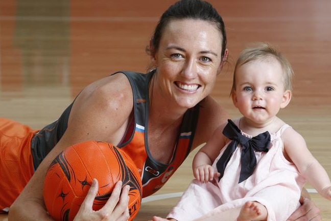 Bulley lies on the netball court next to her baby daughter, Indie