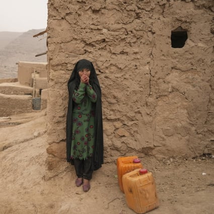 An Afghan girl warms up her hands as she rests from carrying the water in Balucha, Afghanistan, on December 14, 2021. The effects of climate change on women and girls are an increasingly pressing concern, as shown by a recent case before the European Court of Human Rights. Photo: AP