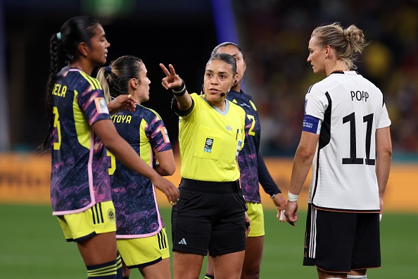 Referee talking to players