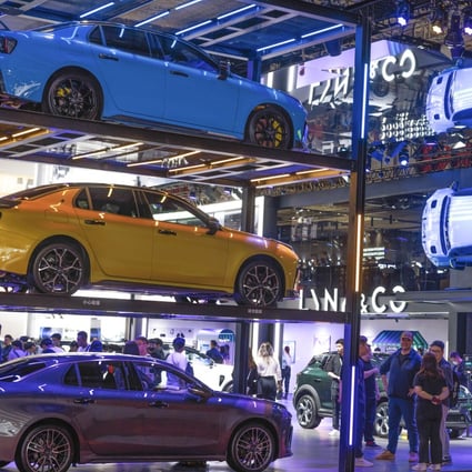 People walk at the Link & Co company booth during the second press day of the 20th Shanghai International Automobile Industry Exhibition in Shanghai on April 19, 2023. China’s auto industry, an electric vehicles in particular, are seen as a bright spot in global semiconductor demand. Photos: EPA-EFE