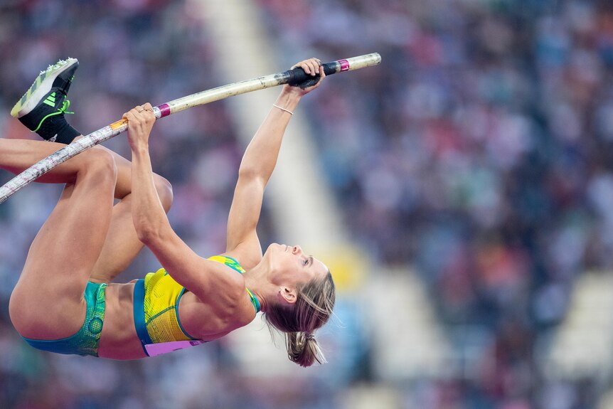 Nina Kennedy ;eans back as she vaults