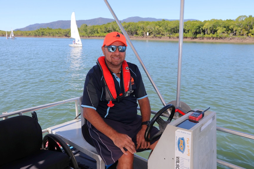 Man in orange cap on boat