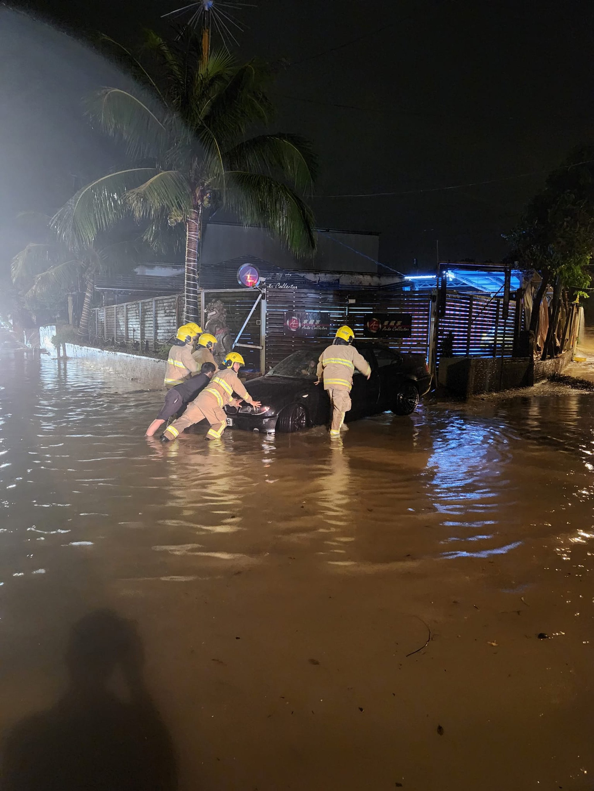 Workers clear a vehicle amid floodwater in Yuen Long. The rural region of Hong Kong was not spared the overnight deluge on Thursday. Photo: Facebook/Jason Leung