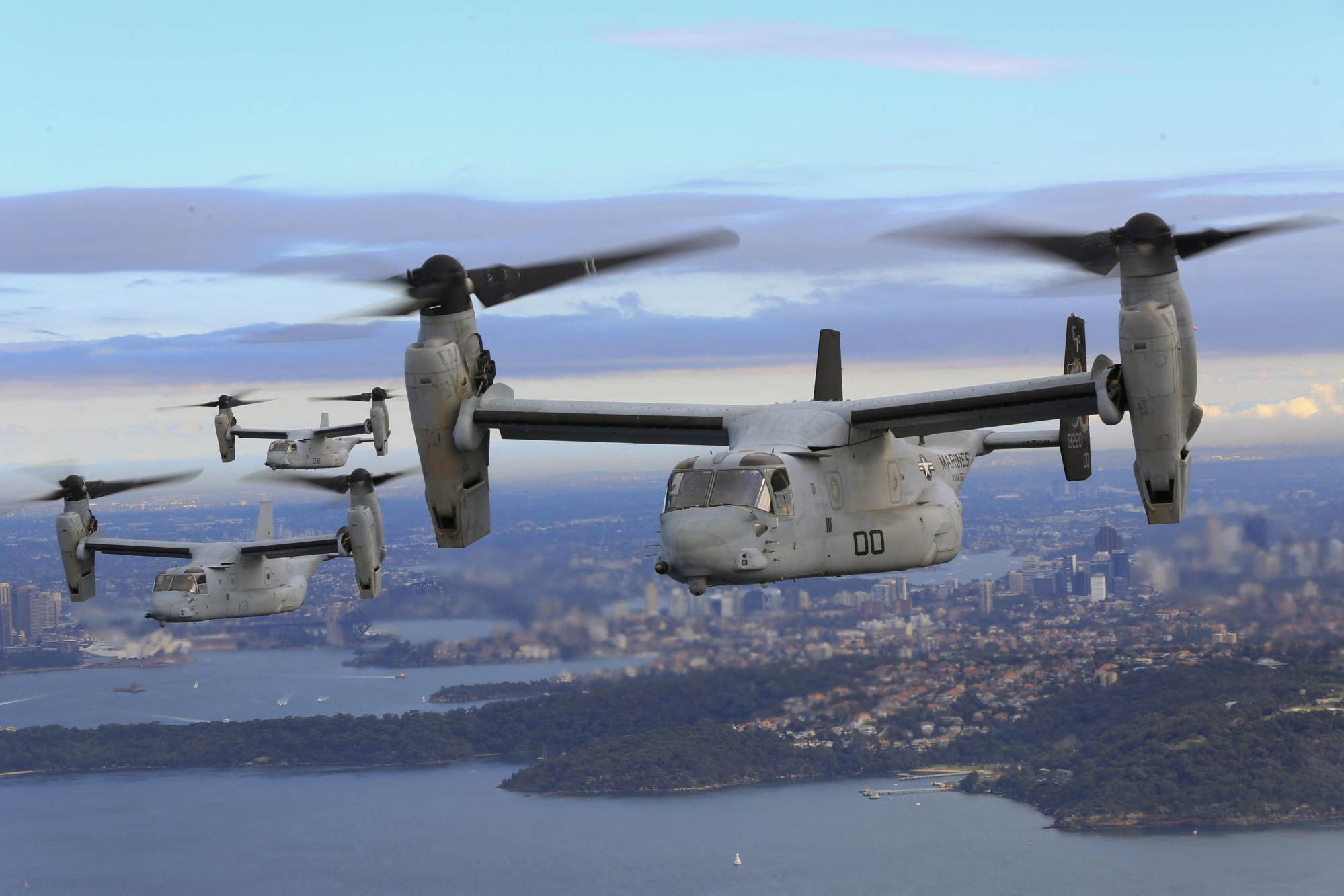 MV-22B Osprey tilt-rotor aircraft fly above Sydney. Activists in Japan claim the aircraft have a poor safety record. Photo: US Marine Corps via AFP