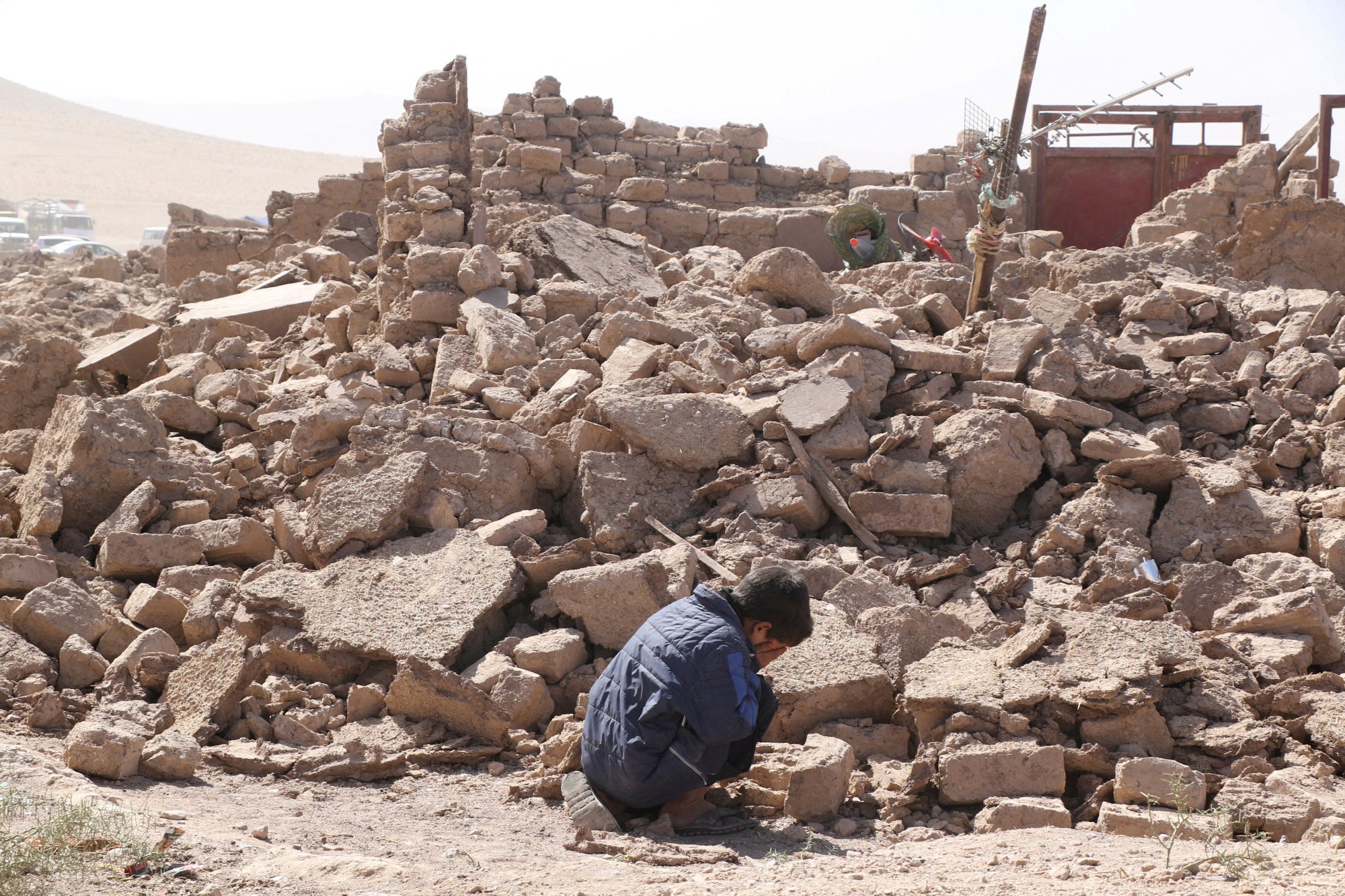 A boy cries next to debris in Zenda Jan district, Herat province, Afghanistan. Photo: Reuters