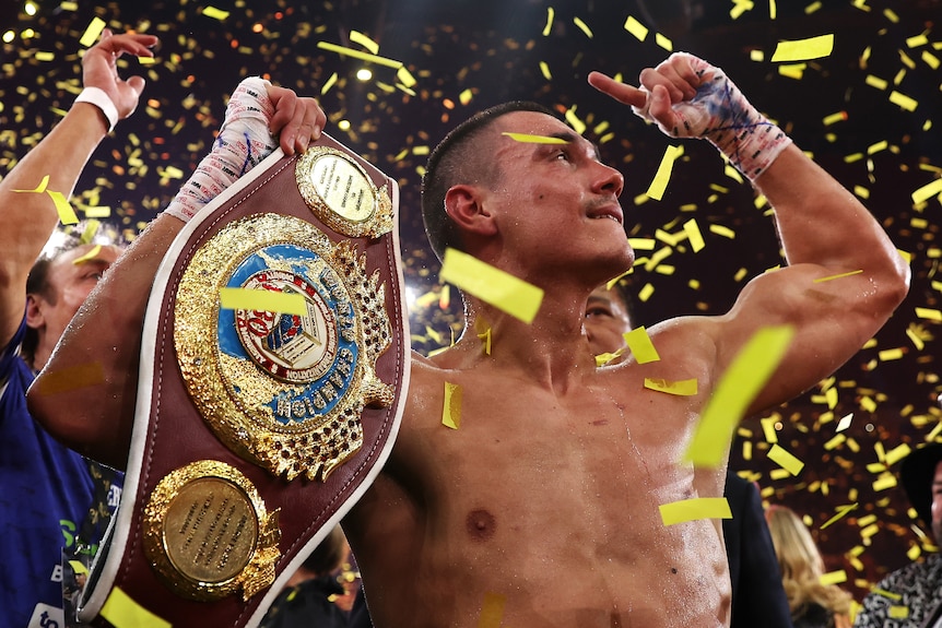 Tim Tszyu holds a boxing belt