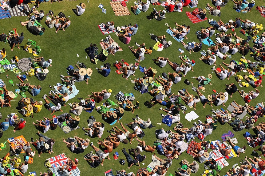Spectators sit on the hill