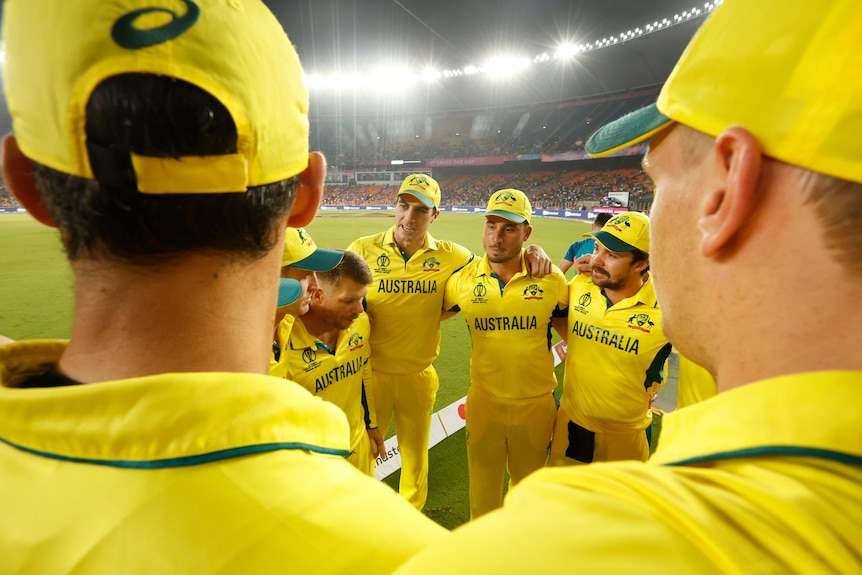 Pat Cummins talks to his players