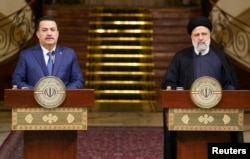 FILE —Iraqi Prime Minister Mohammed Shia al-Sudani and Iranian President Ebrahim Raisi attend a press conference in Tehran, Iran, November 6, 2023.