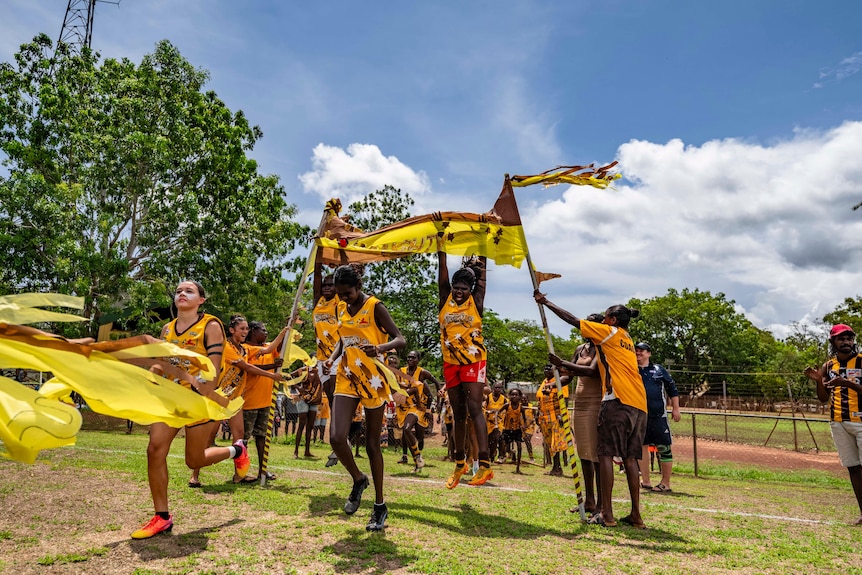 The Tapalinga Superstars run out onto the field.