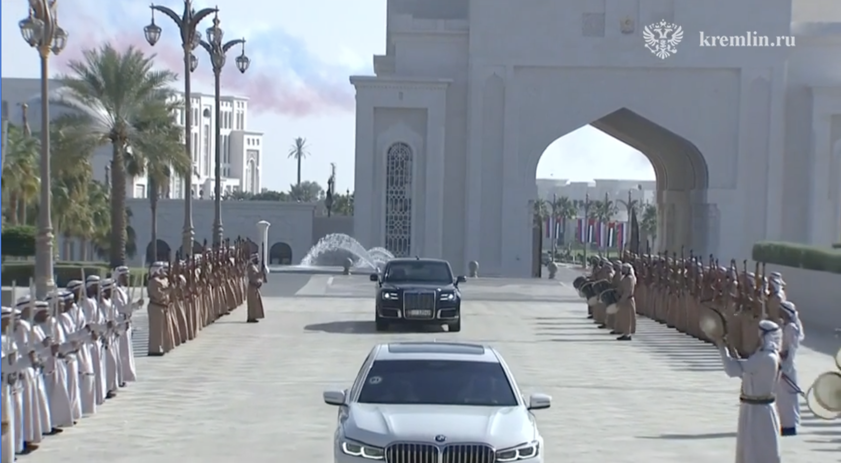 Putin was greeted with a guard of honour from men singing, playing music and holding what looks like weapons