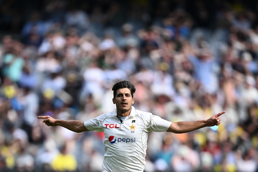 Mir Hamza runs with his arms wide apart