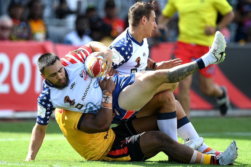 A man is tackled during a rugby league match