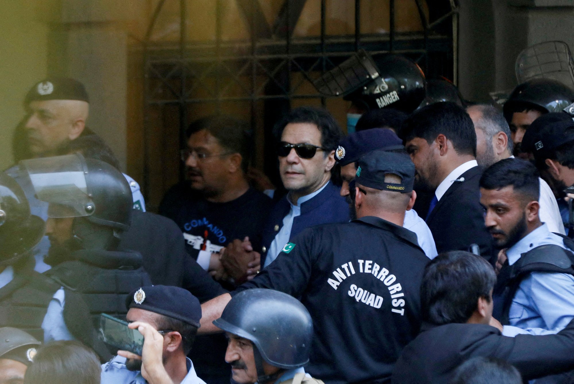 Security officers escort Pakistan’s former prime minister Imran Khan as he appeared in Islamabad High Court on May 12. Photo: Reuters
