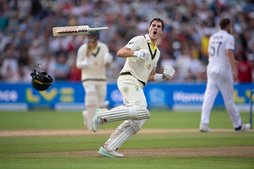 Pat Cummins throws his bat and celebrates