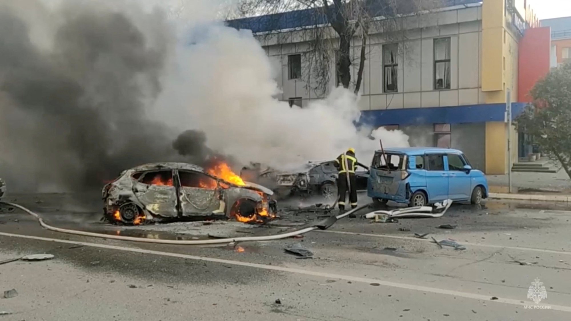 A firefighter works to extinguish a burning car in Belgorod, Russia. Photo: Reuters