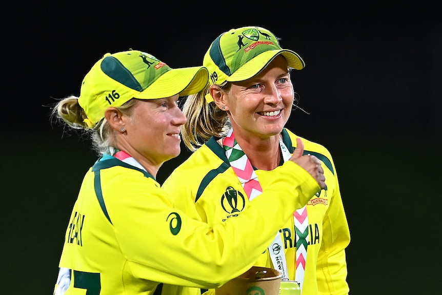 Meg Lanning and Alyssa Healy stand and smile