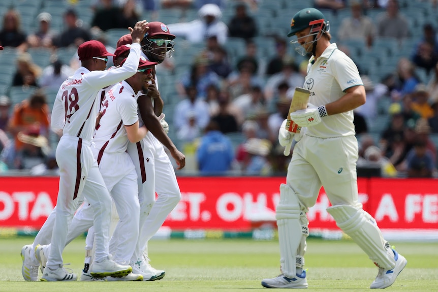 Justin Greaves is hugged as Mitch marsh walks off