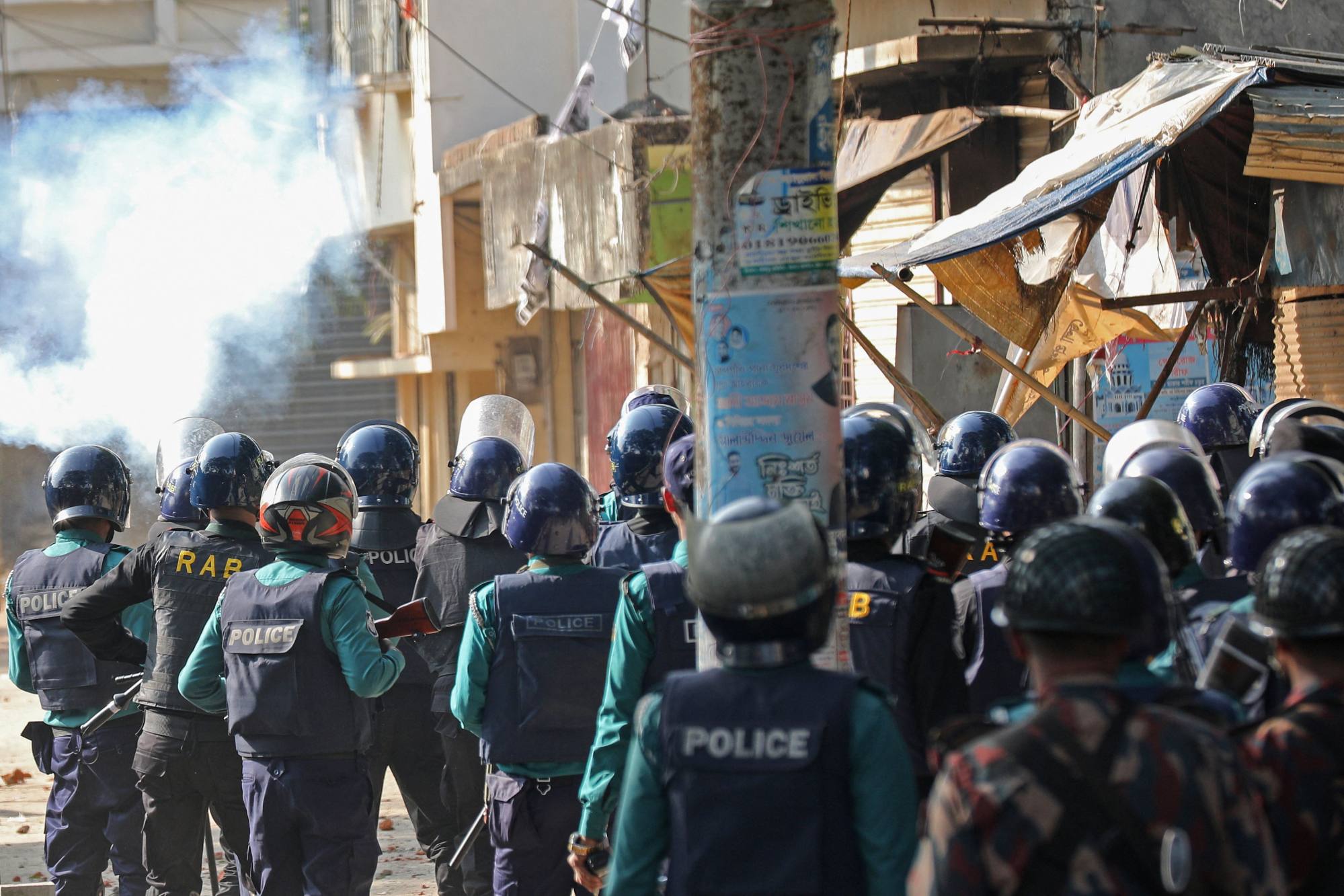 Police fire tear gas to disperse a mob during a protest in Chittagong, Bangladesh on Sunday. Photo: AFP