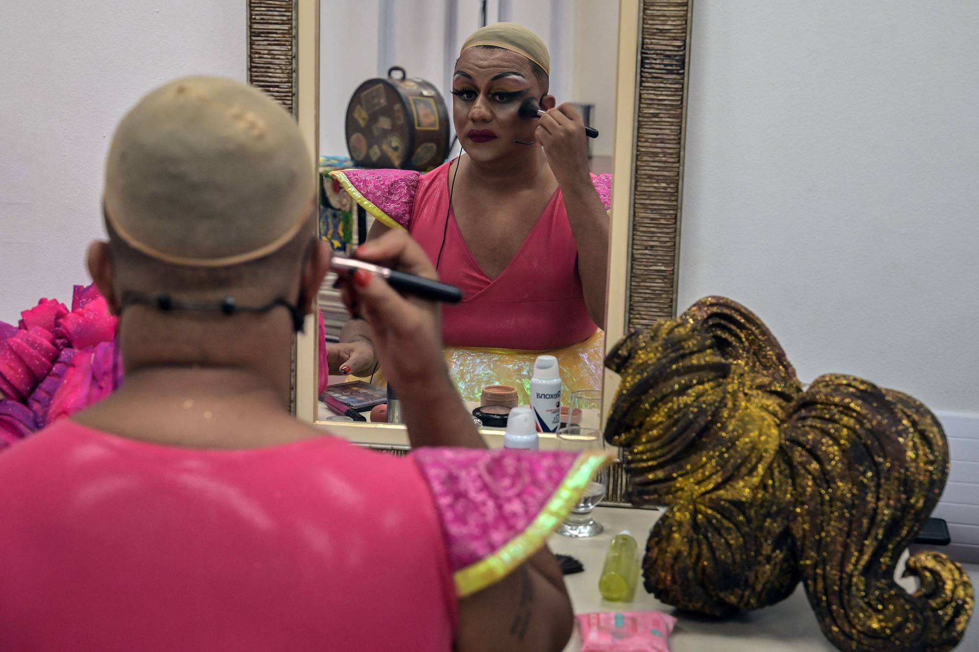 Brazilian drag queen Paulo Reis, known as Helena Black, puts make-up on before performing. Photo: AFP