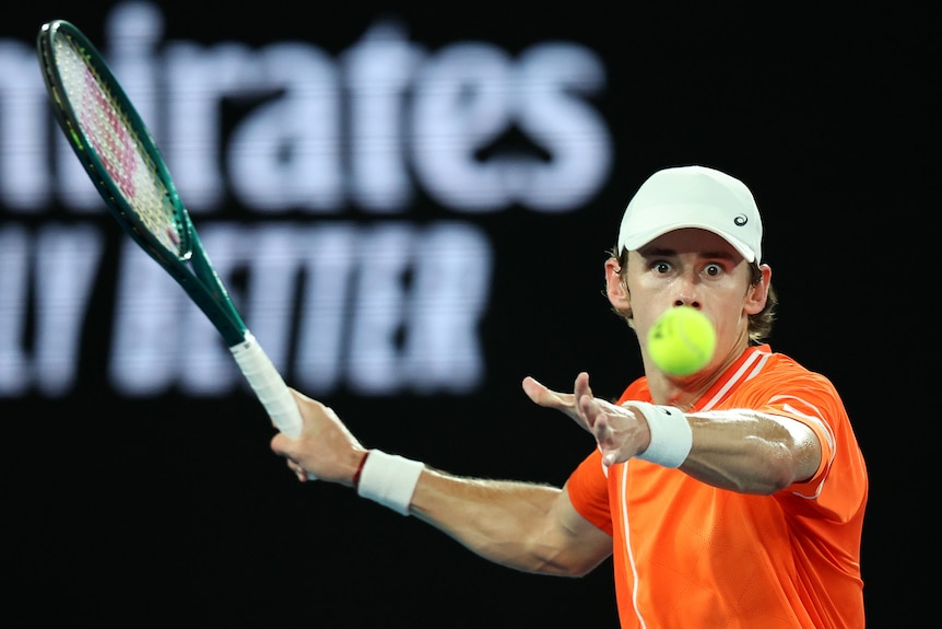 Alex de Minaur stares at the ball as he prepares to play a forehand at the 2024 Australian Open.