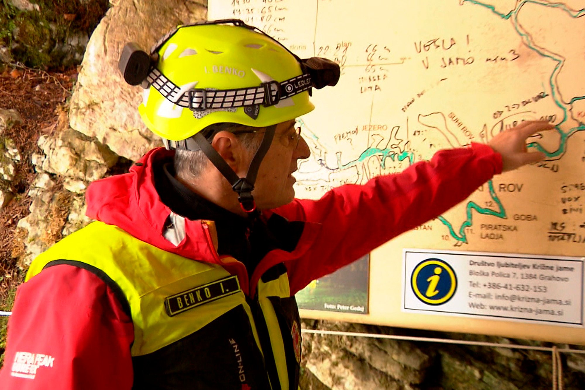 aveA rescuer inspects the map of Krizna Jama cave near Grahovo, Slovenia on Sunday, Photo: Pop TV via AP