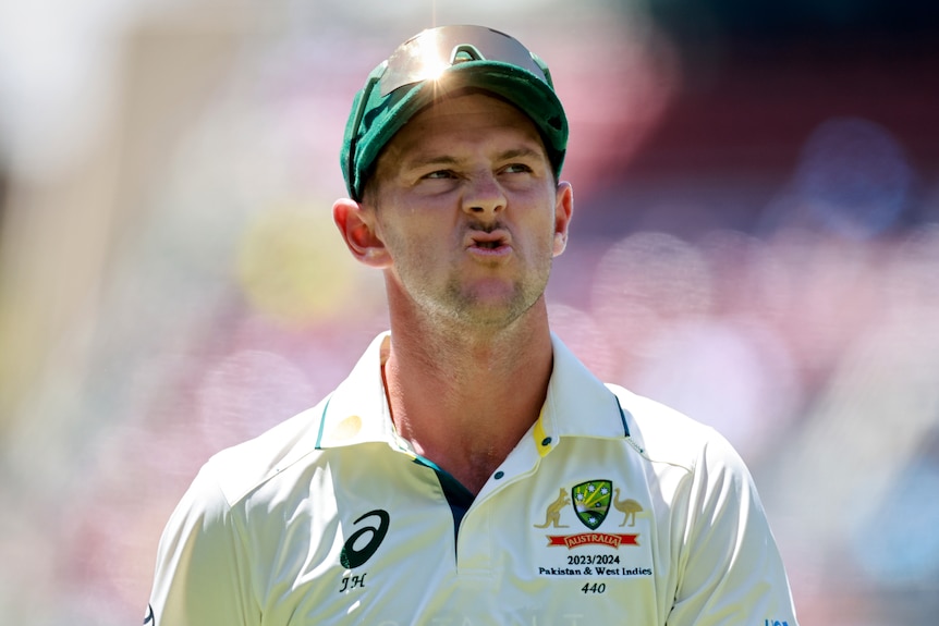 Josh hazlewood pulls a face