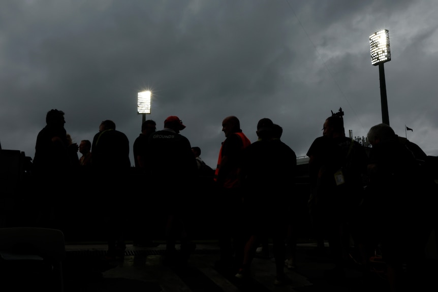 Silhouettes of spectators in the crowd under lights at the SCG during a Test between Australia and Pakistan.