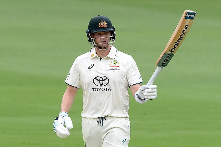 Steve Smith holds up the bat
