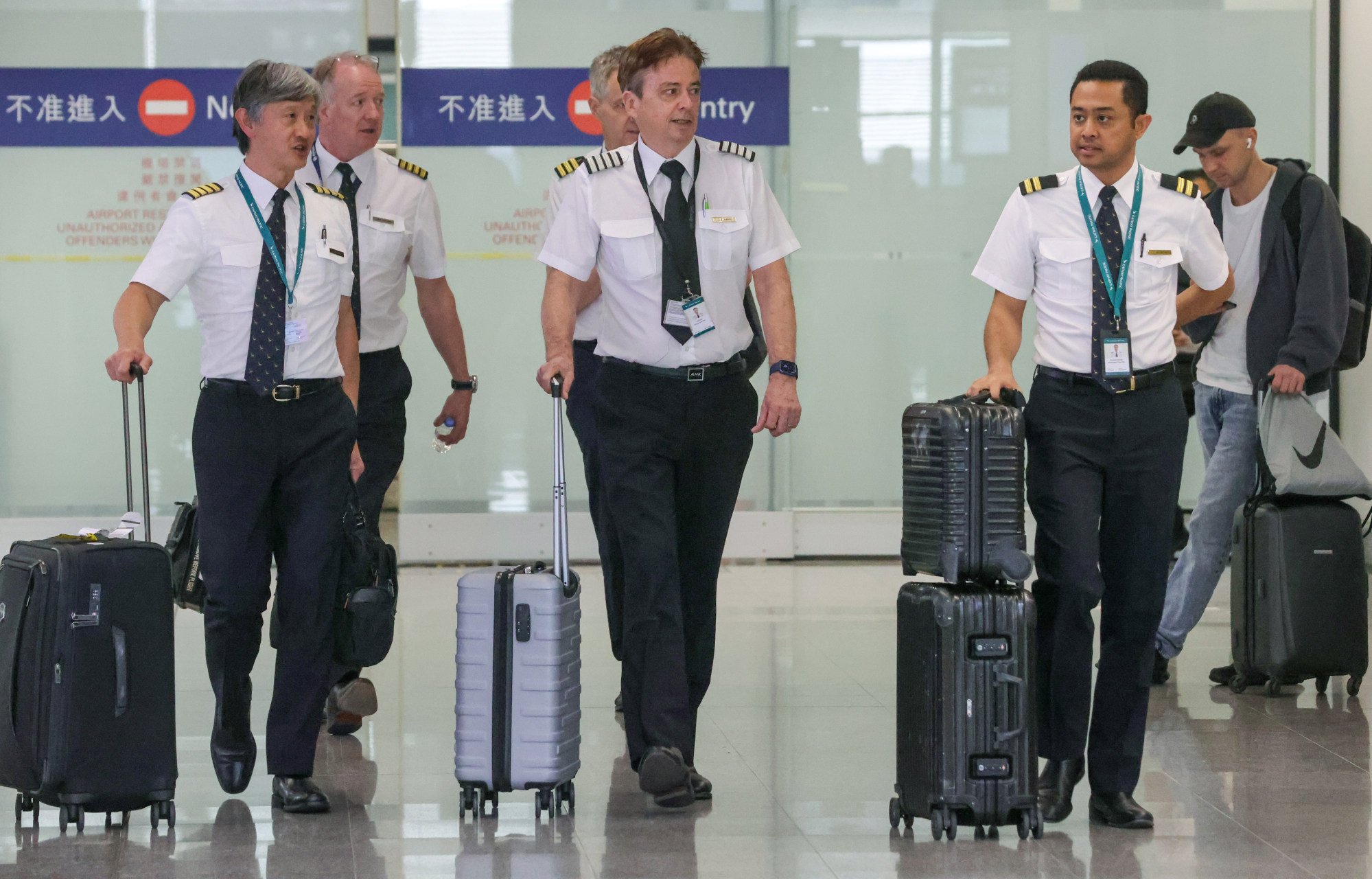 Cathay Pacific employees at Hong Kong International Airport. Lowering the requirement for training eligibility is not a solution to the manpower crunch, says the Hong Kong Aircrew Officers Association chairman. Photo: May Tse
