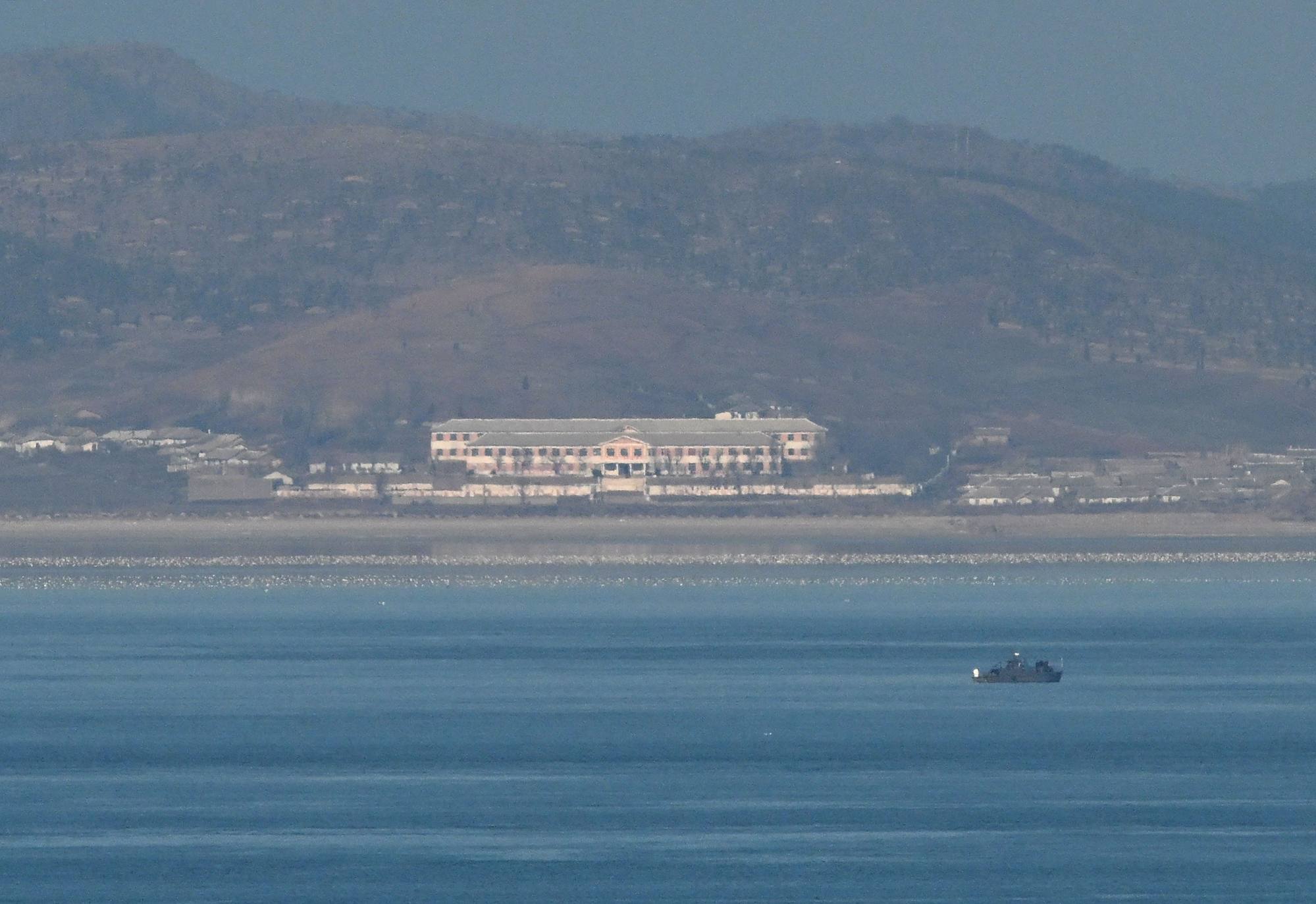 An unidentified boat before the North Korean coastline as seen from a viewpoint on Yeonpyeong island, near the “Northern Limit Line: sea boundary with North Korea, on Saturday. North Korea’s military fired over 60 artillery rounds near Yeonpyeong Island on Saturday, Seoul’s military said. Photo: AFP