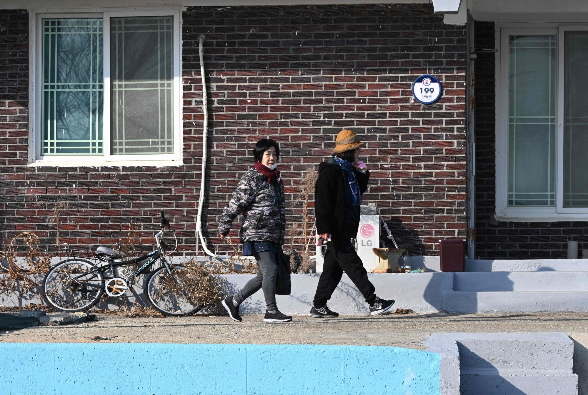 South Korean residents walk through a village of Yeonpyeong island on Saturday. Photo: AFP