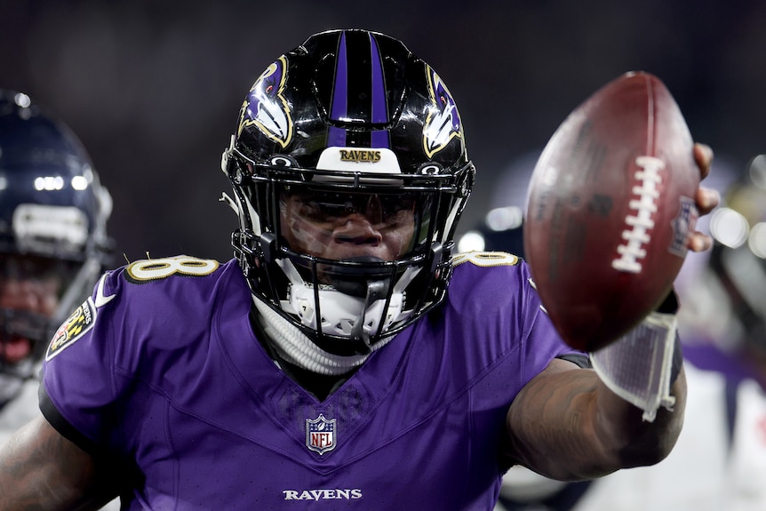 Lamar Jackson holds the ball