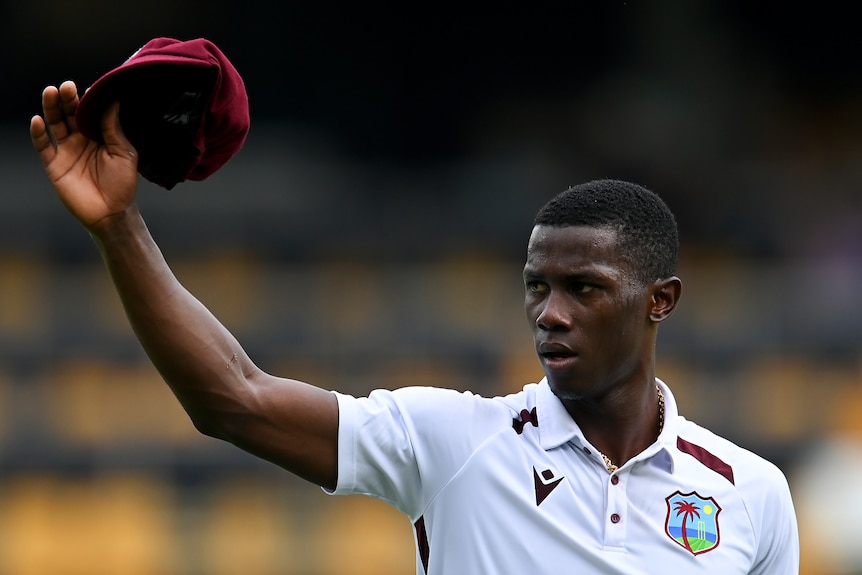 Shamar Joseph holds up his cap