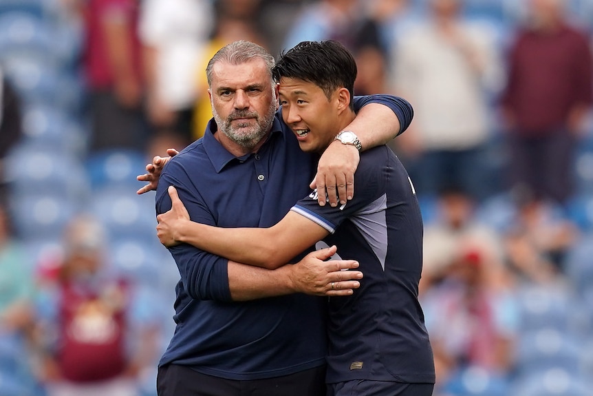 Tottenham Hotspur manager Ange Postecoglou puts his arm around captain Son Heung-Min.