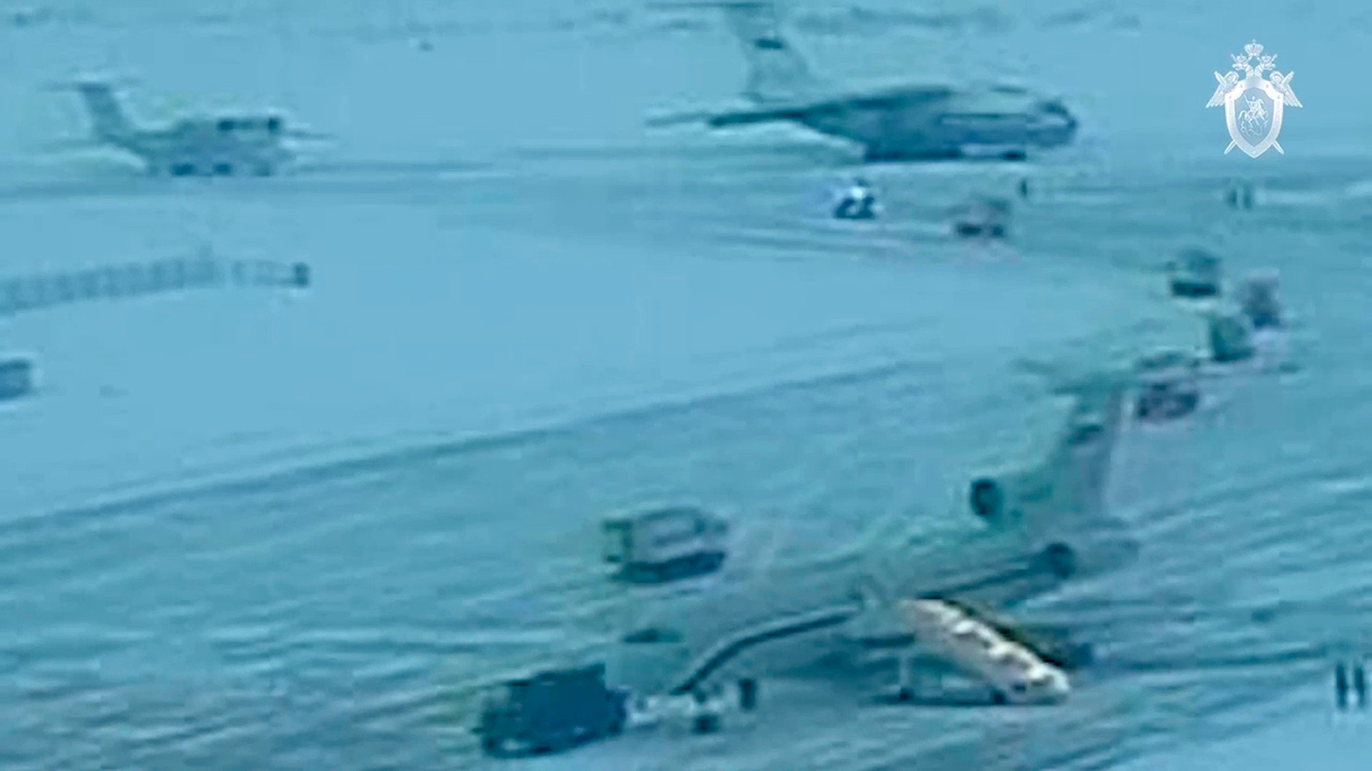 A video is said to show buses parked to load Ukrainian POWs on board a Russian military Il-76 plane. Photo: Russian Investigative Committee via AP