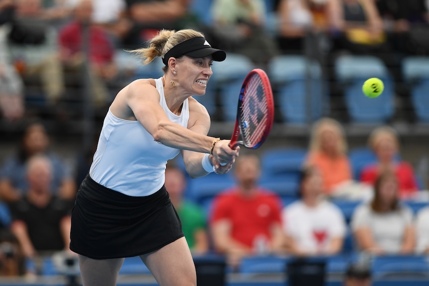 Angelique Kerber gritting her teeth as she hits a tennis ball. 