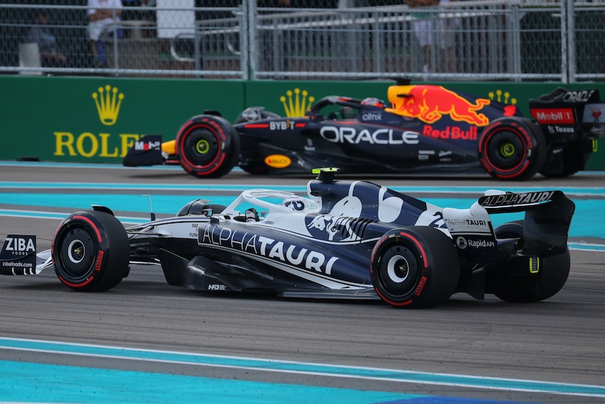 Two F1 cars on track, both bluem preparing for qualifying